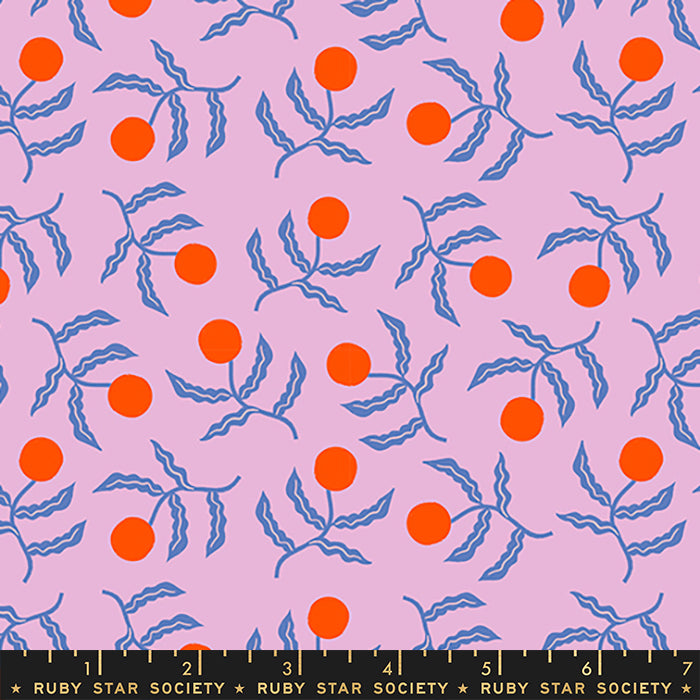 A repeating fabric pattern featuring bright orange cherries on wavy blue stems over a light pink background, with a black ruler strip at the bottom showing measurements and the text 'RUBY STAR SOCIETY'.