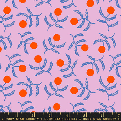 A repeating fabric pattern featuring bright orange cherries on wavy blue stems over a light pink background, with a black ruler strip at the bottom showing measurements and the text 'RUBY STAR SOCIETY'.