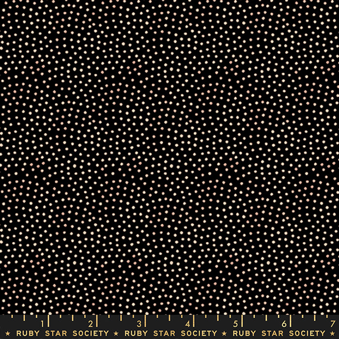 Black fabric with a dense pattern of small white and light beige dots, shown flat with a Ruby Star Society ruler along the bottom edge.