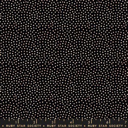 Black fabric with a dense pattern of small white and light beige dots, shown flat with a Ruby Star Society ruler along the bottom edge.