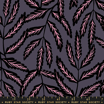 A close-up of a fabric pattern featuring stylized pink leaves on black stems against a dark charcoal gray background, with a Ruby Star Society ruler visible along the bottom edge.