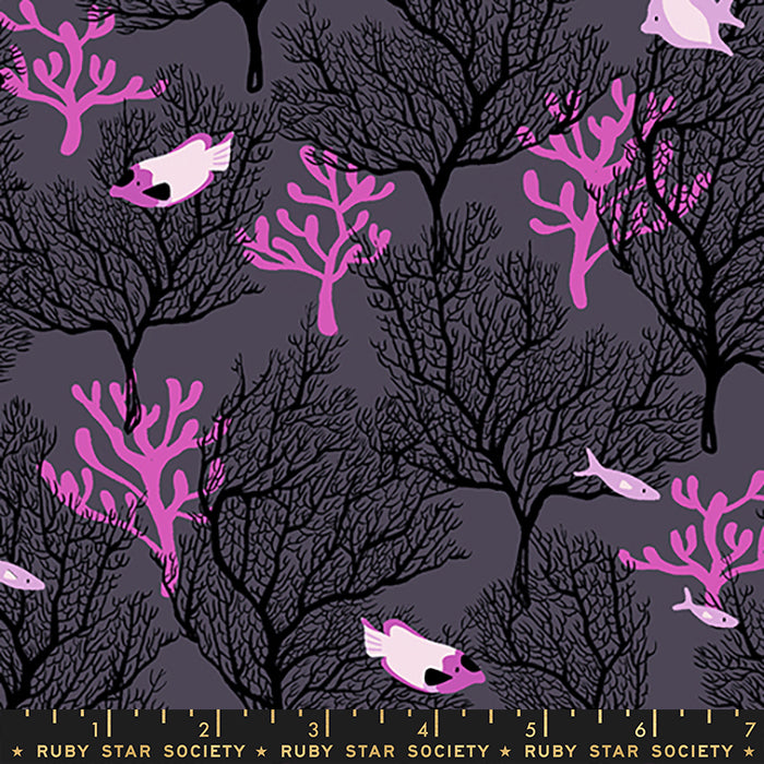 Fabric with a repeating pattern of black coral trees and pink fish on a dark gray background, with a ruler strip at the bottom showing measurements and the text Ruby Star Society.