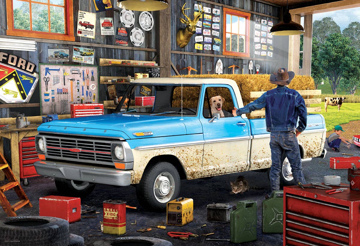 Puzzle picture of man standing next to a blue and white truck in a garage with tools and equipment around.
