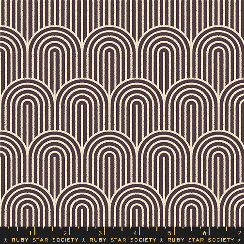 A repeating fabric pattern featuring cream-colored arches and vertical lines on a dark brown background, with a black ruler at the bottom showing the Ruby Star Society brand and scale markings.