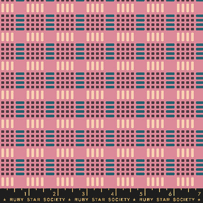 Fabric with a repeating geometric pattern featuring pink, dark purple, teal blue, and cream blocks and dashes, with a black ruler strip at the bottom labeled Ruby Star Society.