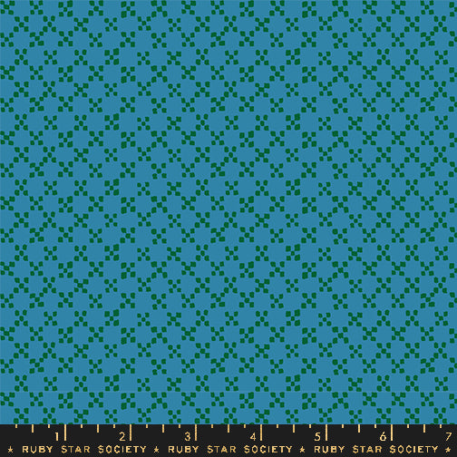 A close-up of a repeating fabric pattern in teal and dark green, with a dark ruler strip along the bottom edge labeled Ruby Star Society.