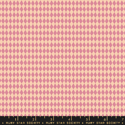 A close-up of a repeating harlequin diamond pattern in dusty pink and pale peach, with a black ruler strip along the bottom edge labeled Ruby Star Society.