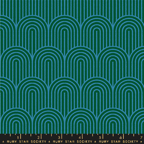 Fabric with a repeating geometric pattern of teal and blue arches on a dark green background, with a black ruler strip along the bottom edge labeled Ruby Star Society.