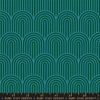 Fabric with a repeating geometric pattern of teal and blue arches on a dark green background, with a black ruler strip along the bottom edge labeled Ruby Star Society.