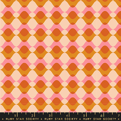 Fabric with a repeating mid-century modern geometric pattern featuring wavy horizontal bands in orange, peach, pink, and cream, with a black ruler at the bottom showing the Ruby Star Society brand and measurements.