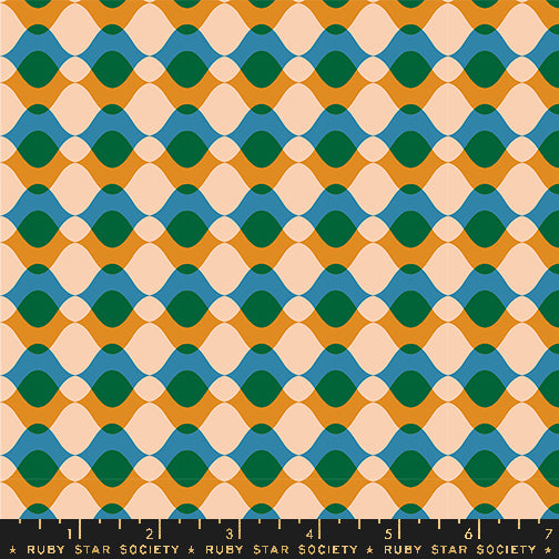 Fabric with a repeating geometric pattern of wavy horizontal bands in mustard yellow, teal blue, dark green, and pale peach, with a black ruler along the bottom edge marked Ruby Star Society.