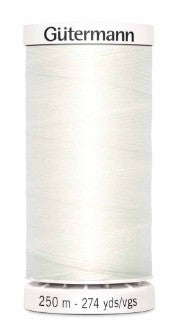 Spool of Gutermann thread with label on a white background
