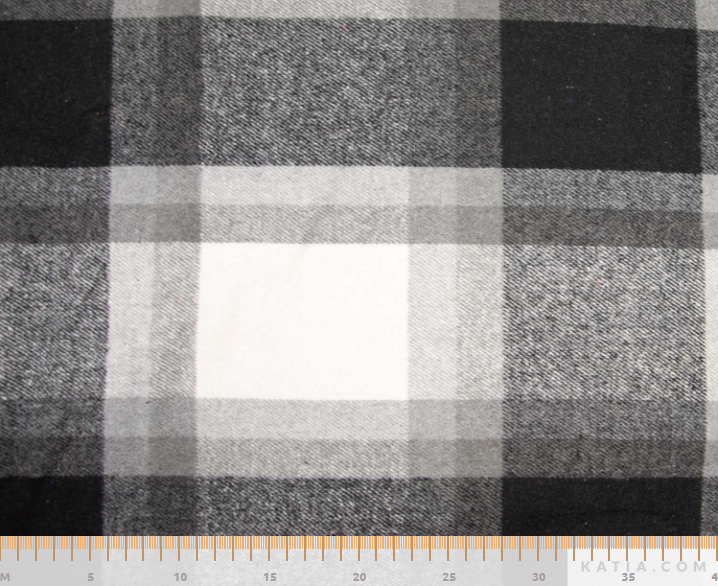 Black, gray, and white plaid fabric with a visible ruler along the bottom edge for scale.