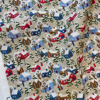 Fabric with winter snowy houses design from Liberty of London for sewing quilting and crafting. 