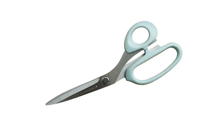 Pair of fabric scissors with light blue handles on a white background for sewing and crafting.