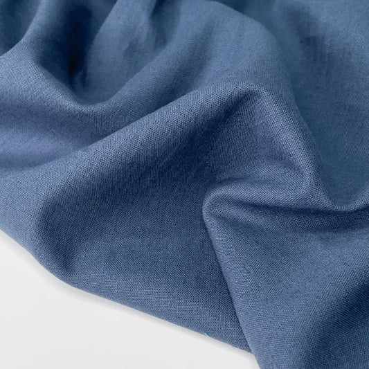 Close up of cotton linen blend fabric in blue for sewing. 