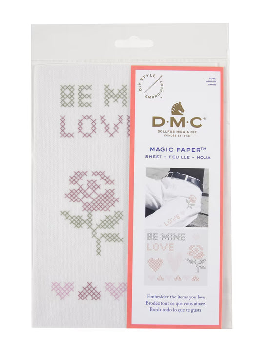 DMC Magic Embroidery Paper with cross-stitch designs and text on a white background