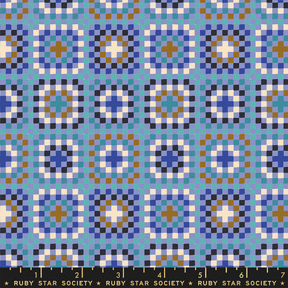 Patterned fabric with geometric design in blue, white, and brown on a blue background, featuring Ruby Star Society label.