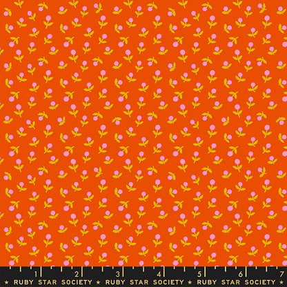 Fabric with small pink flowers on an orange background, labeled Ruby Star Society.