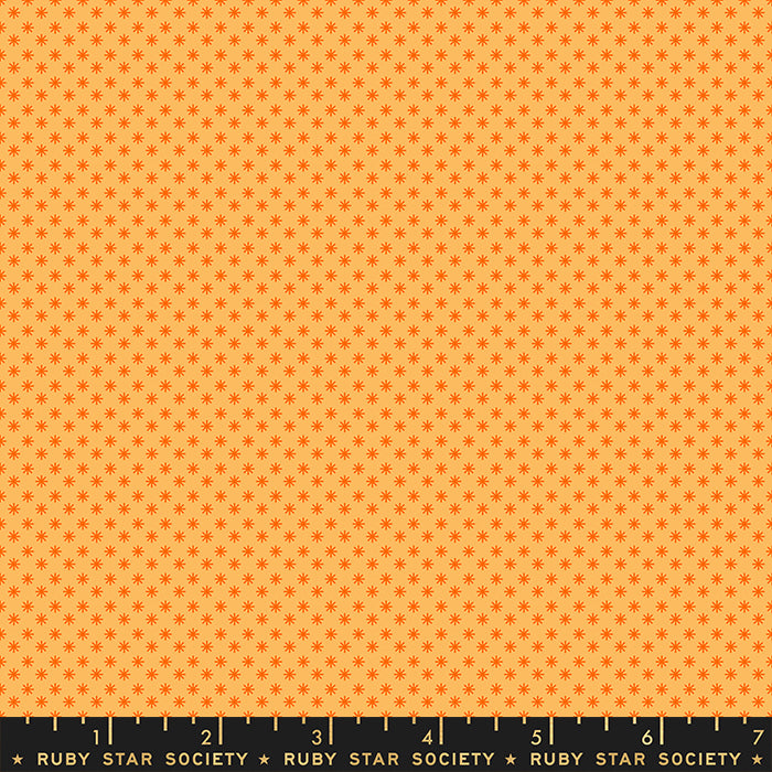Fabric with small star pattern on an orange background, Ruby Star Society label at the bottom.