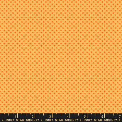 Fabric with small star pattern on an orange background, Ruby Star Society label at the bottom.