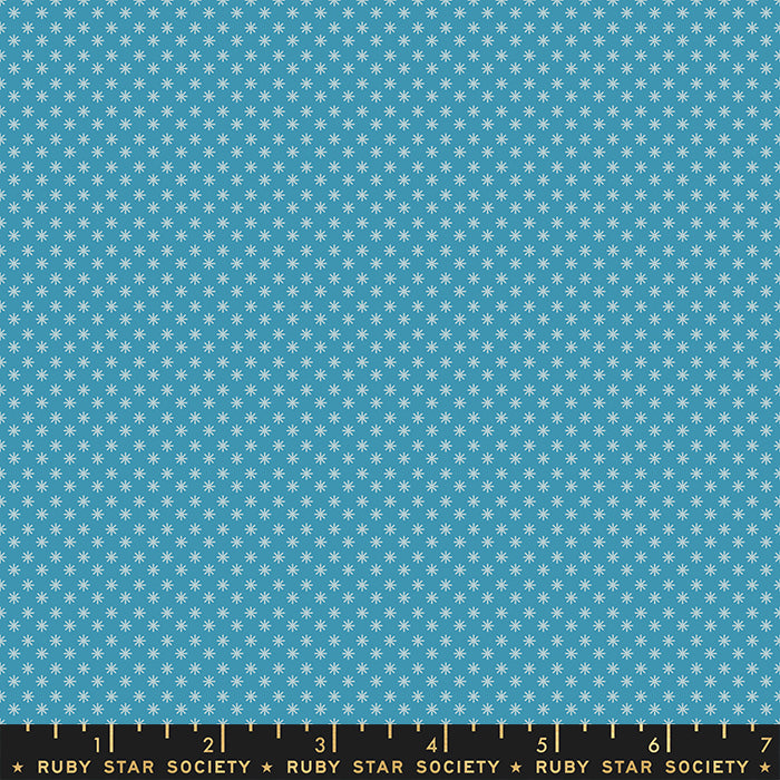 Fabric with small white star pattern on a blue background, featuring Ruby Star Society label.