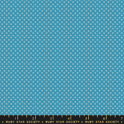 Fabric with small white star pattern on a blue background, featuring Ruby Star Society label.
