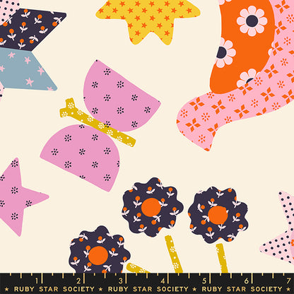 Colorful fabric pattern with flowers, stars, and butterflies on a beige background, featuring Ruby Star Society label.