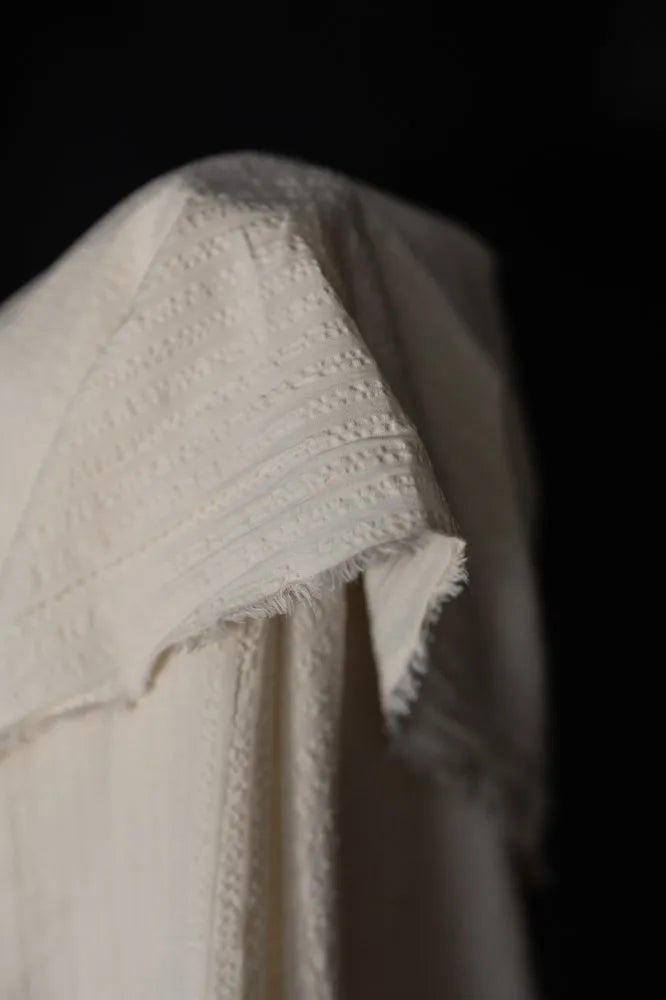 White seeksucker 100% organic cotton fabrics with stripe pattern. For sewing garments, from Merchant & Mills. 
