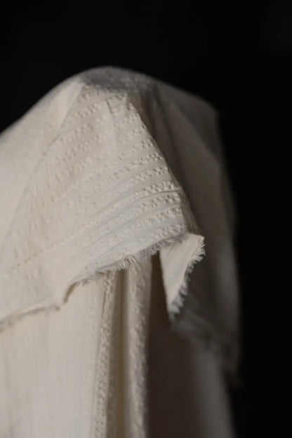 White seeksucker 100% organic cotton fabrics with stripe pattern. For sewing garments, from Merchant & Mills. 