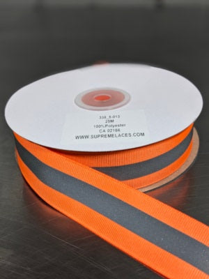 Spool of orange reflective tape for safety sewing crafting.
