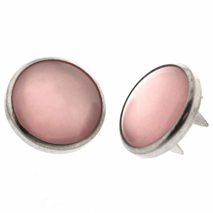 Pair of pearl snaps on a white background