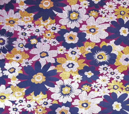 Colorful floral pattern brocade material with purple, yellow, and white flowers on a dark background