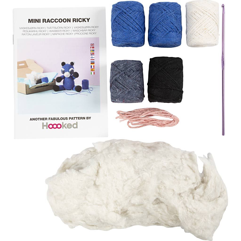 contents of a crochet kit including yarn and needle.