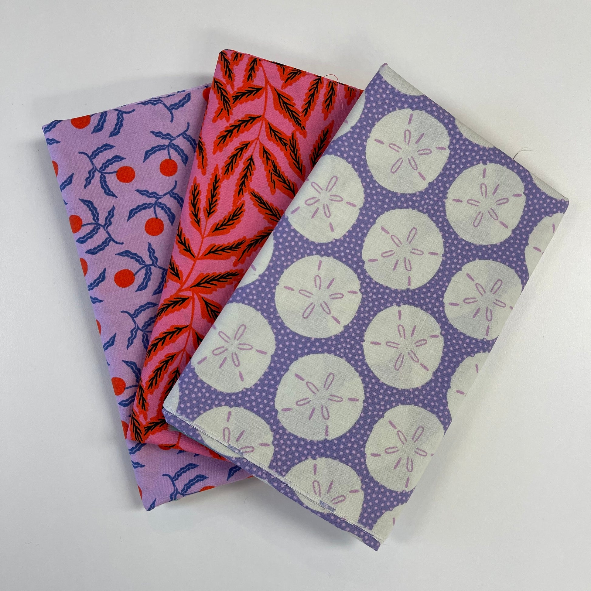Three fabric swatches with different patterns on a white background