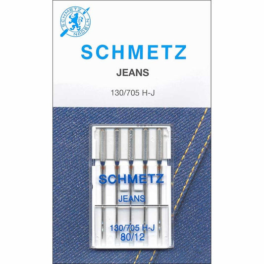 Pack of Schmetz jeans sewing machine needles on a denim background with Schmetz logo.