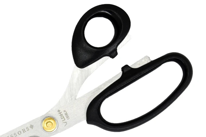 Pair of left handed scissors with black handles on a white background