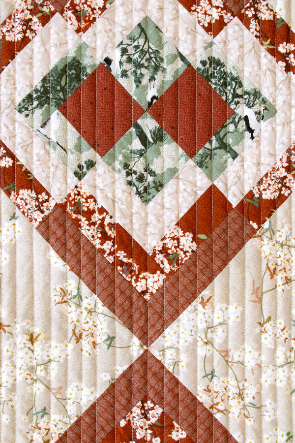 Quilt with diamond pattern and floral elements on a white background from Soar by Katerina Roccella Art Gallery Fabrics premium cotton for sewing and crafting.