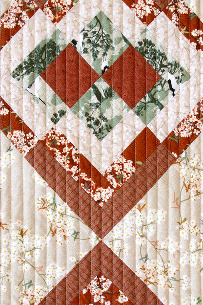 Quilt with diamond pattern and floral elements on a white background from Soar by Katerina Roccella Art Gallery Fabrics premium cotton for sewing and crafting.