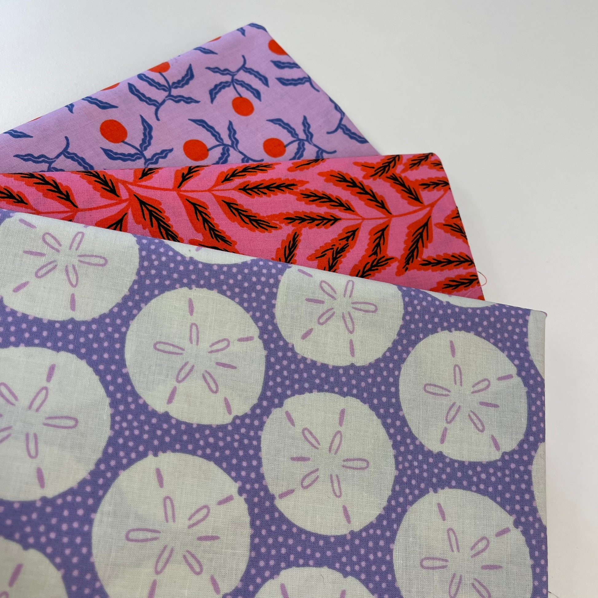 Three fabric swatches with different patterns on a white background