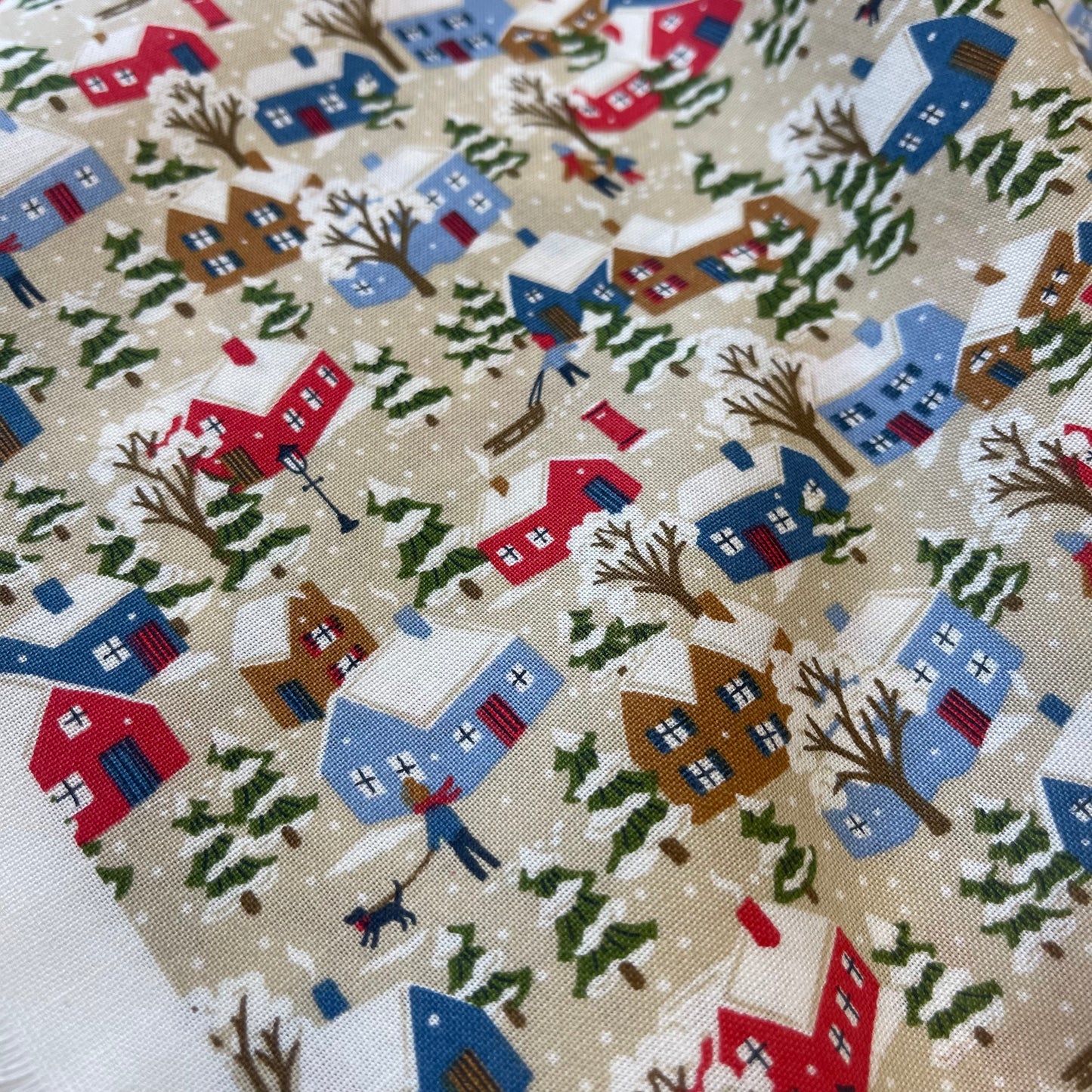 Fabric with winter snowy houses design from Liberty of London for sewing quilting and crafting. 