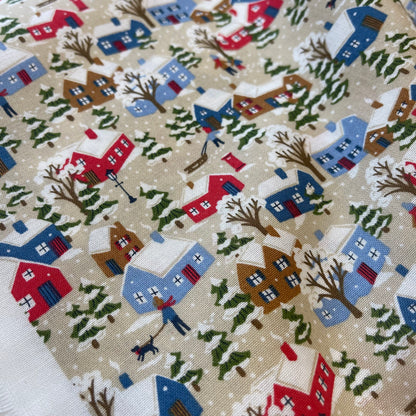 Fabric with winter snowy houses design from Liberty of London for sewing quilting and crafting. 