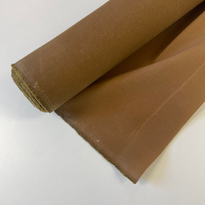 A close-up of a khaki brown waxed canvas fabric material for sewing and crafting and bag making.