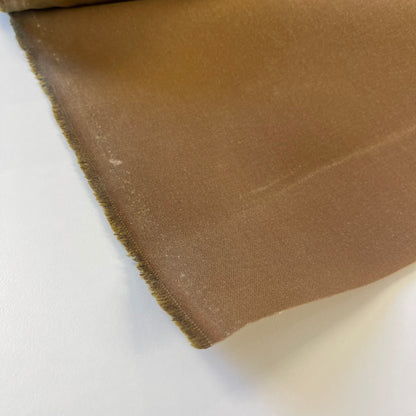 A close-up of a khaki brown waxed canvas fabric material for sewing and crafting and bag making.
