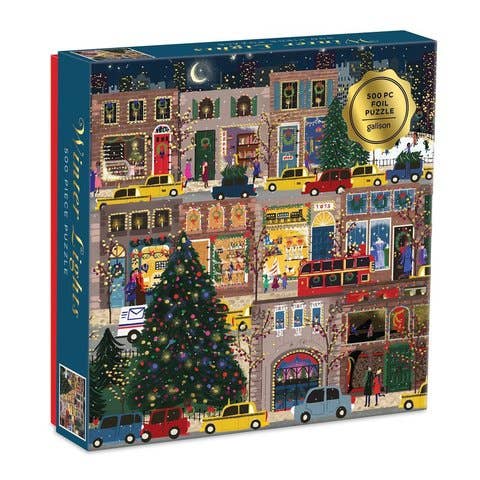 A 500-piece jigsaw puzzle box titled 'Winter Night' by the brand 'puzzle'. The box features a colorful, detailed illustration of a snowy city street at night with Christmas trees, colorful cars, and lit-up storefronts.