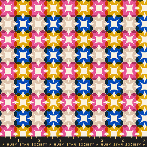 Patterned fabric with colorful geometric design on a beige background, featuring the Ruby Star Society label.