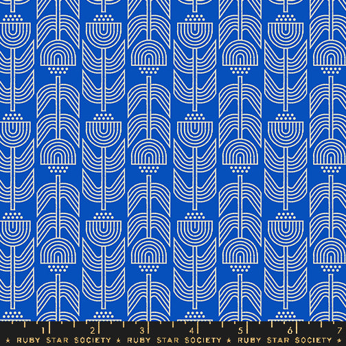 Patterned fabric with white geometric shapes on a blue background, featuring Ruby Star Society label.