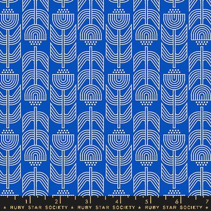 Patterned fabric with white geometric shapes on a blue background, featuring Ruby Star Society label.