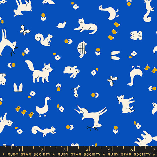 Pattern of white animals on a blue background with a ruler at the bottom.