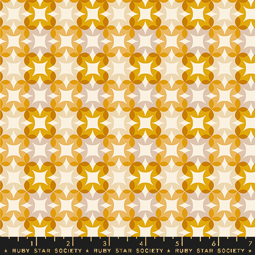 Patterned fabric with geometric design in orange and white on a beige background, featuring Ruby Star Society label.